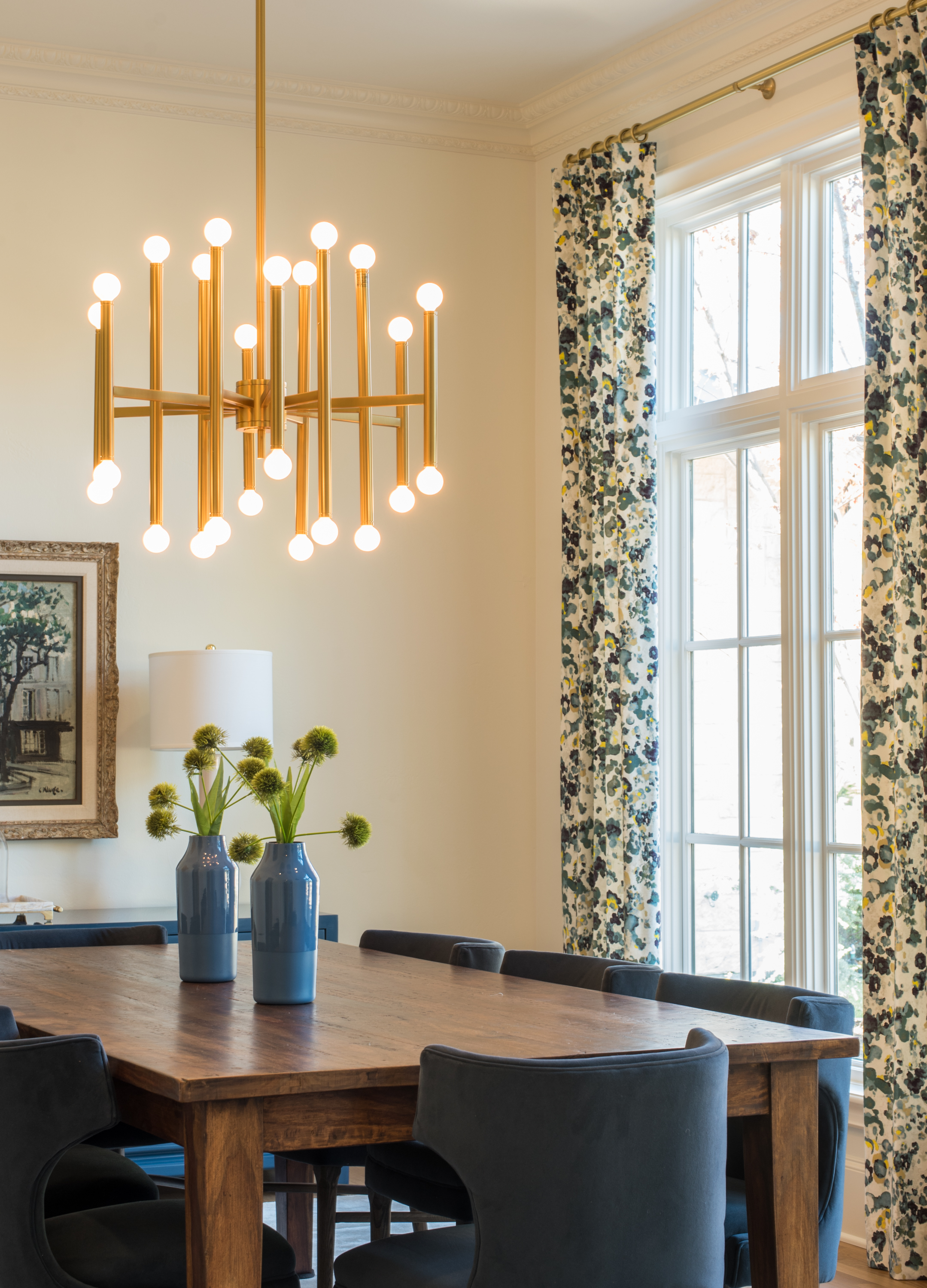 Living room with velvet sofa and floral curtains
